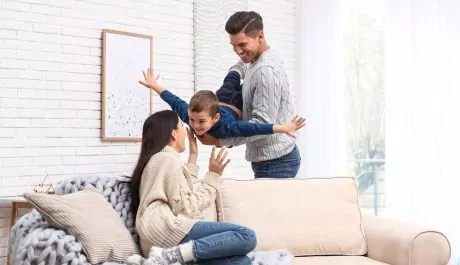 Happy family with little son having fun at home. Winter vacation